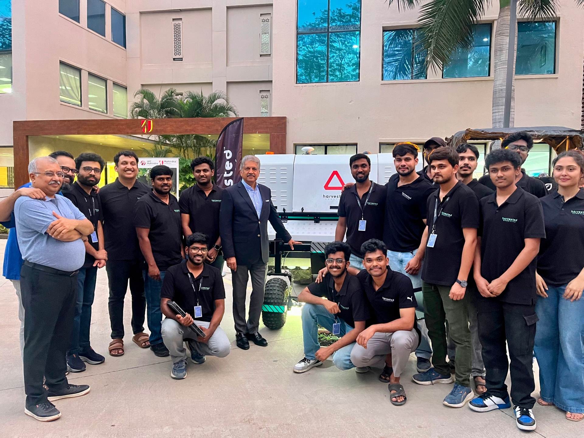 The Harvested Robotics team gathered around the Rakshakh machine